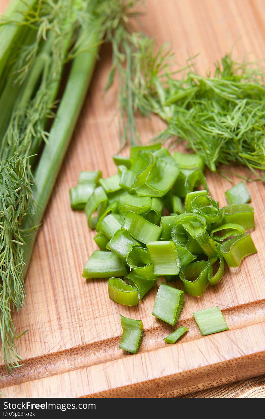 Dill, parsley on chopping board