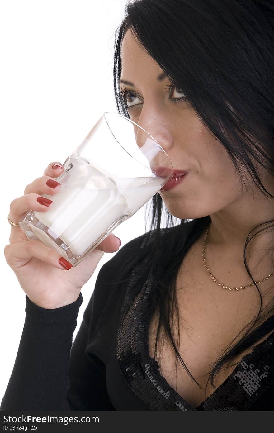 Brunette girl in a black pullover drinking milk