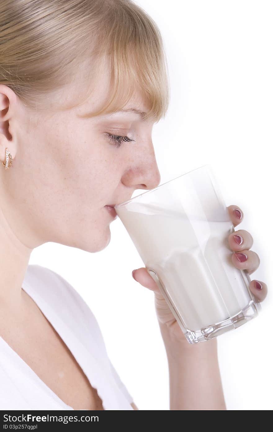 Young blonde girl drinking a milk