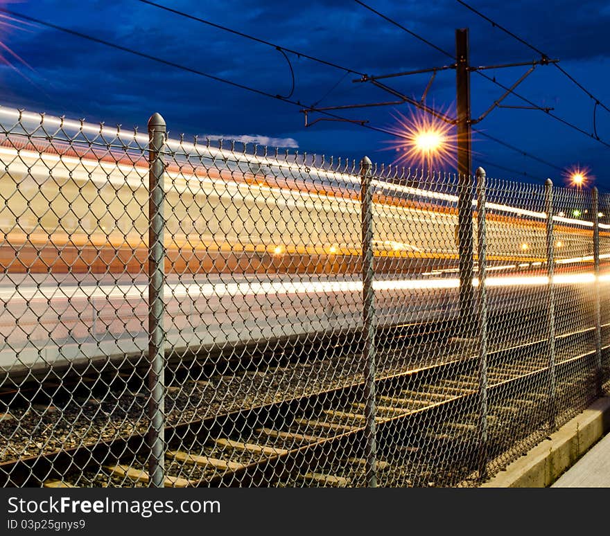 Denver Colorado's Municipal Light Rail Speeding southbound on Interstate 25. Denver Colorado's Municipal Light Rail Speeding southbound on Interstate 25.