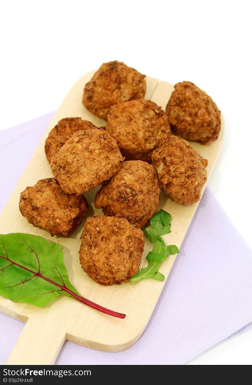 Meatballs on kitchen board isolated on white