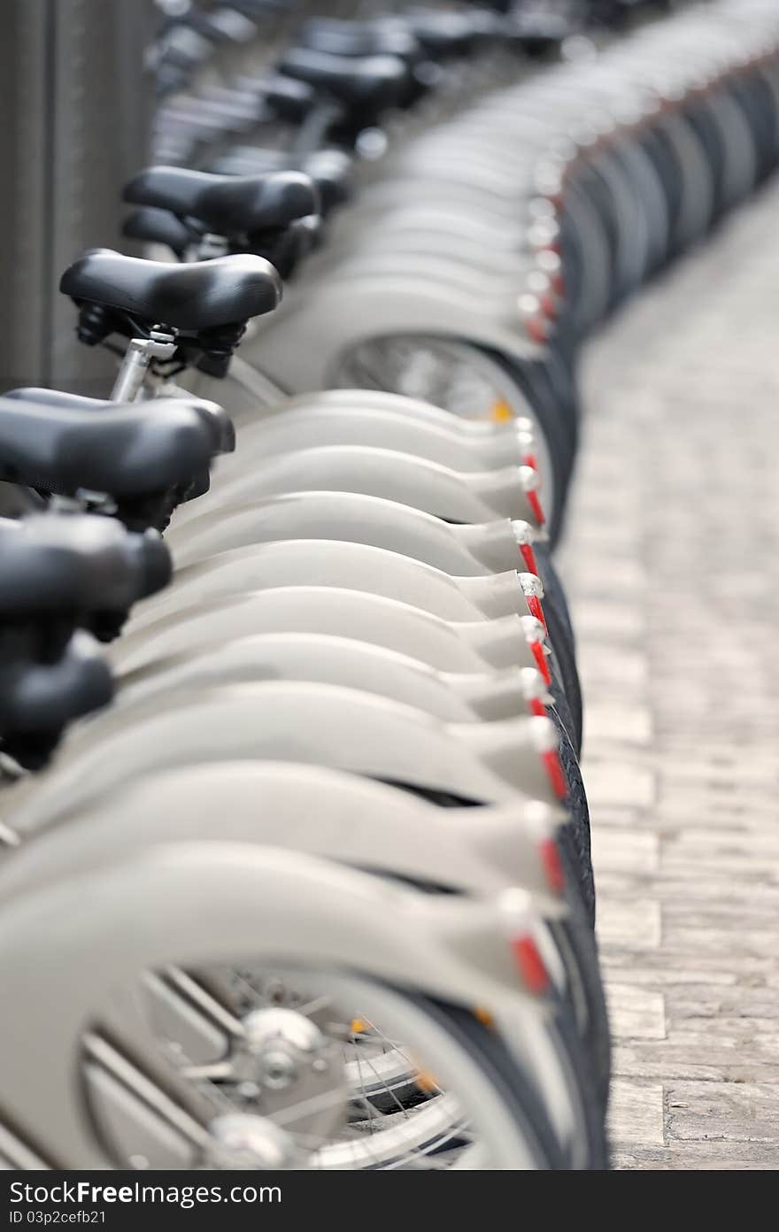 Wheels of bicycles on the walkway. Photo with tilt-shift lens. Wheels of bicycles on the walkway. Photo with tilt-shift lens