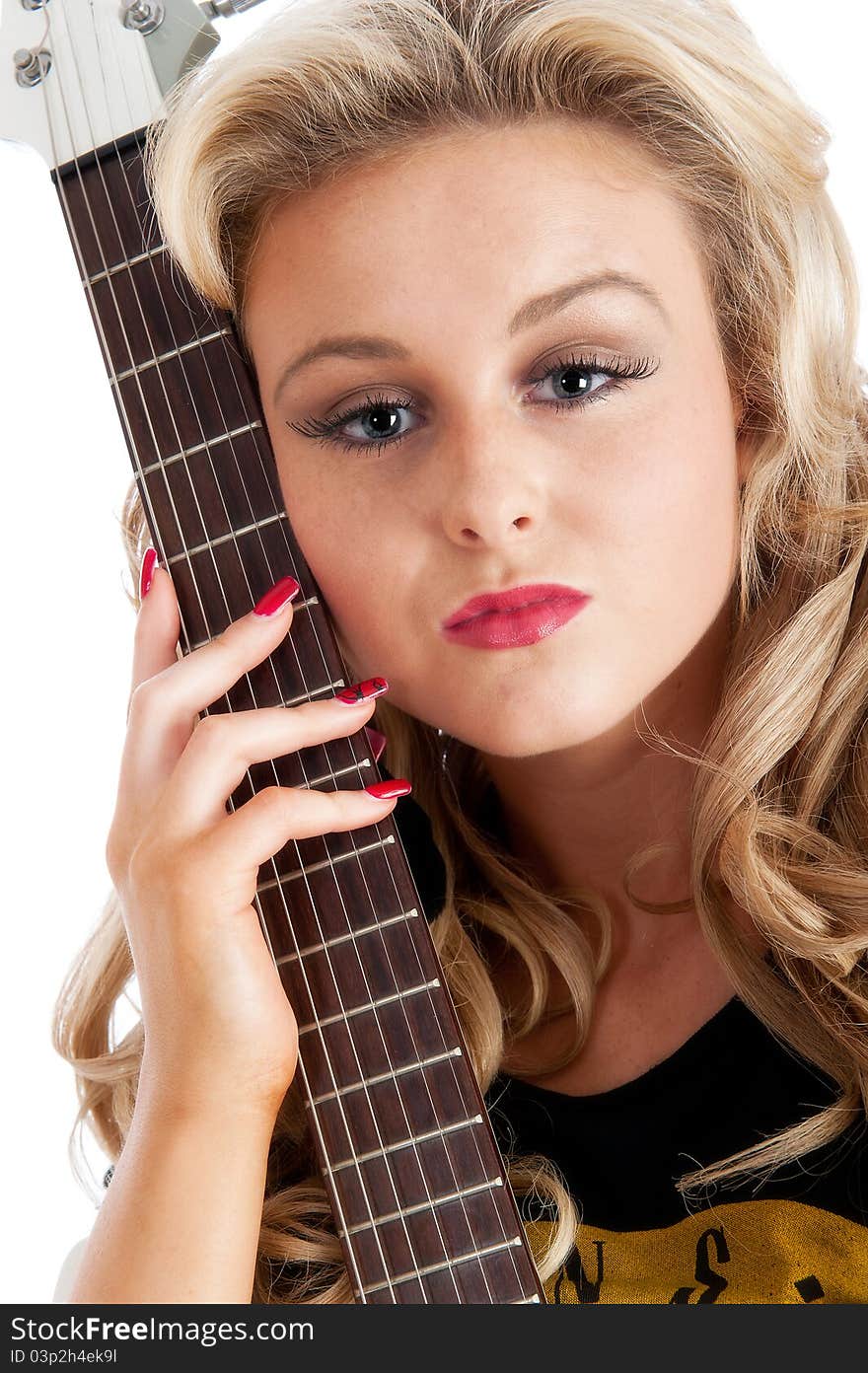 Pretty blonde female posing with guitar