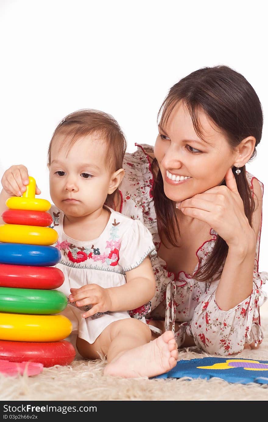 Mom with daughter on carpet on white