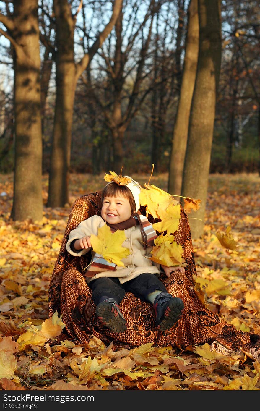 Portrait of a little boy sitting outside in a kiddie chair. Portrait of a little boy sitting outside in a kiddie chair