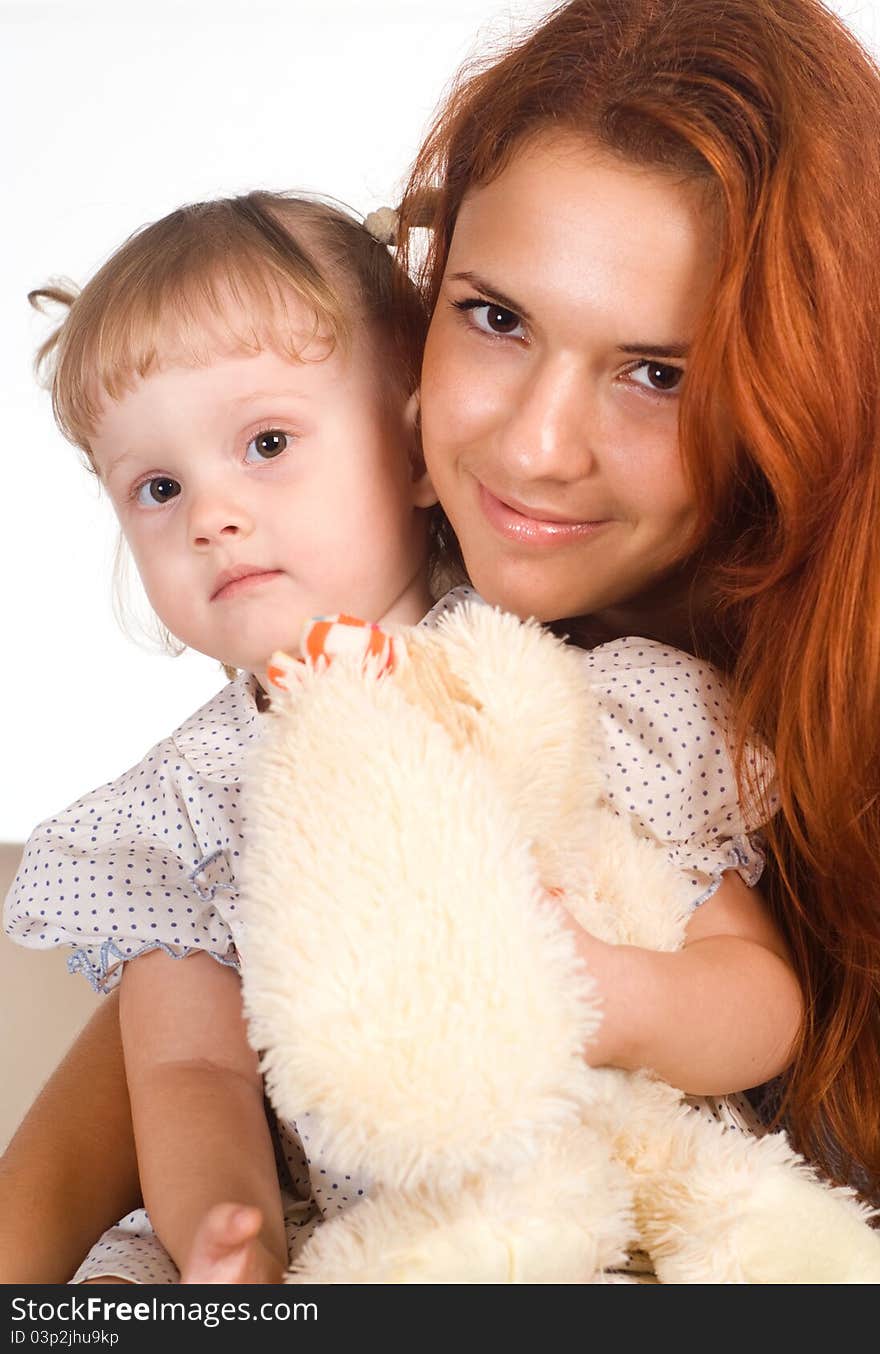 Cute mom and her daughter on a white. Cute mom and her daughter on a white