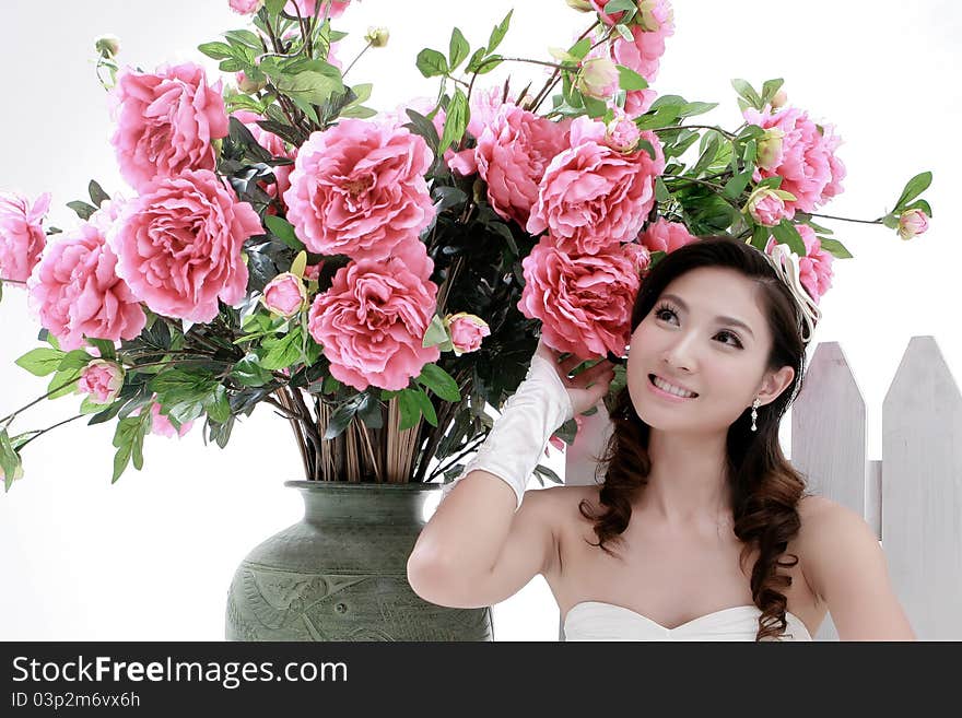 Portrait of young beautiful girl with flower on white background