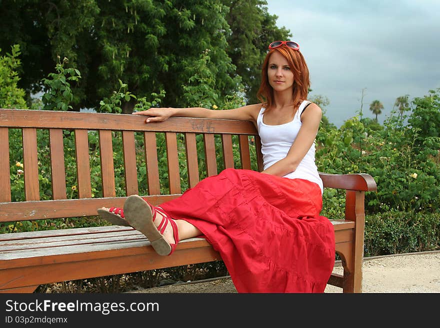 Beautiful young woman relaxing in park. Beautiful young woman relaxing in park