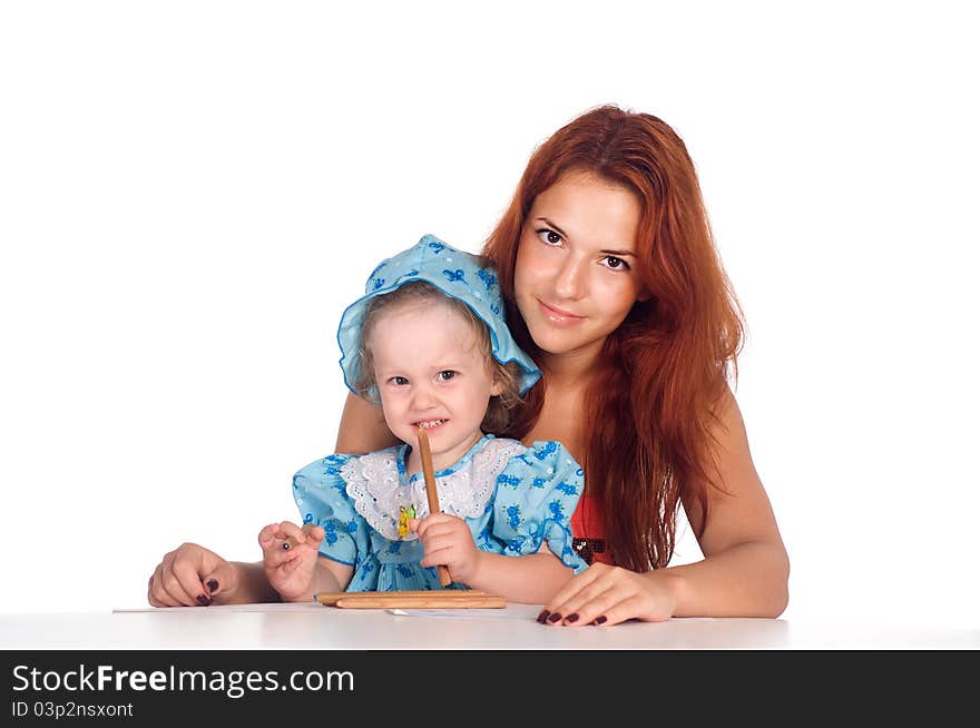 Cute mom and her daughter drawing at table. Cute mom and her daughter drawing at table