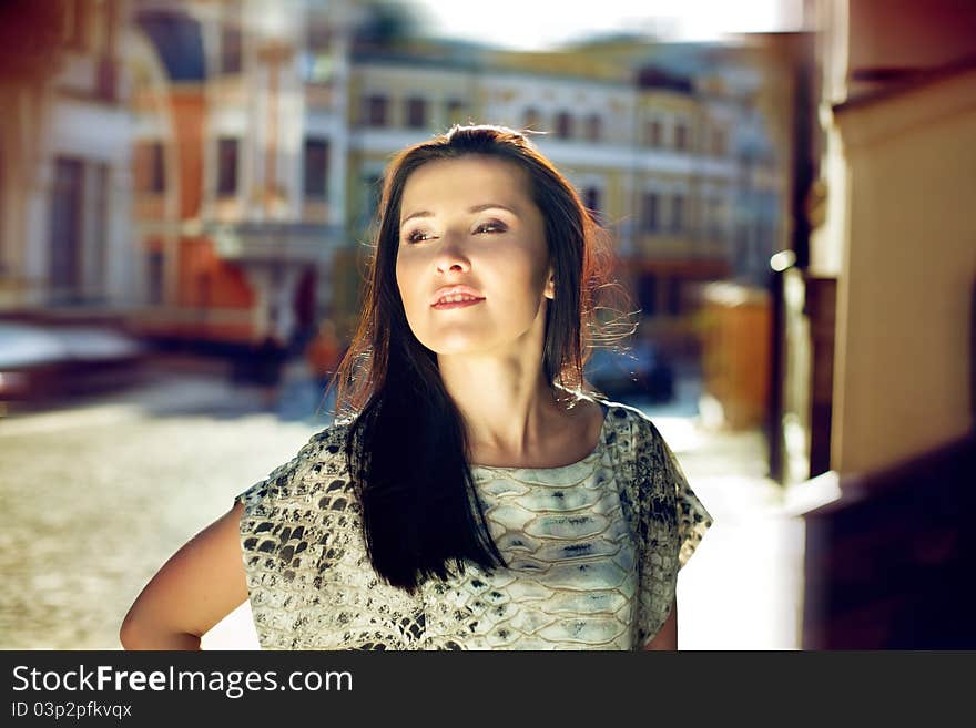 Cute brunette in the urban background. Cute brunette in the urban background