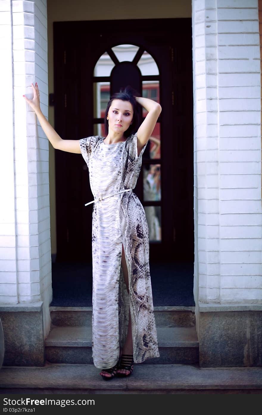 A beautiful young woman in evening dress standing in the hallway