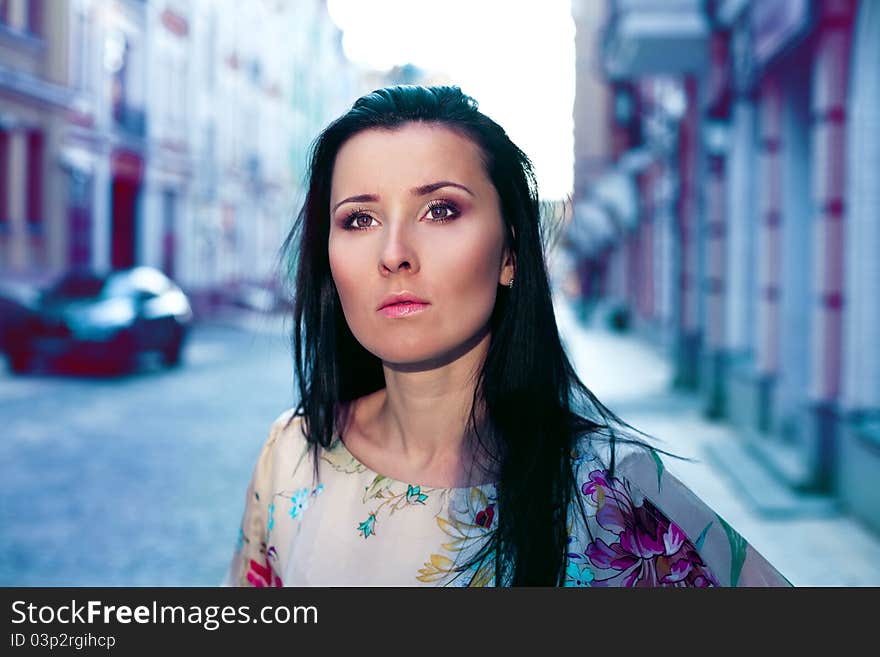 Beautiful young woman in a city at night