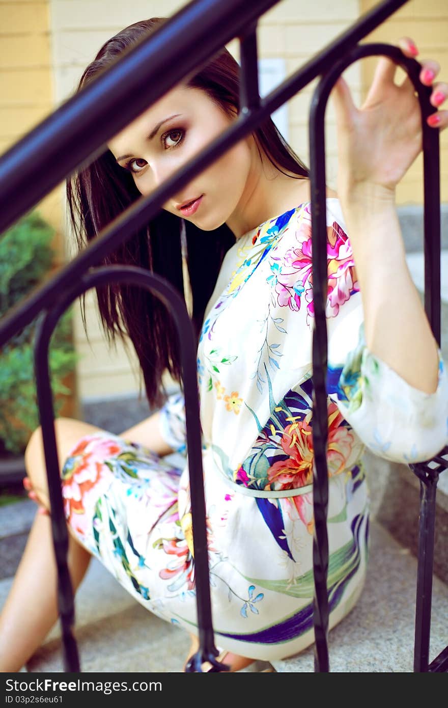 A beautiful woman is sitting on the steps