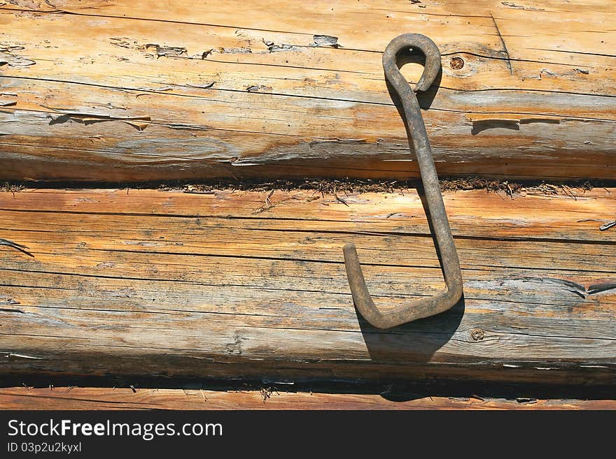 Fragment of wooden frame wall with an iron hook. Texture, background. Fragment of wooden frame wall with an iron hook. Texture, background