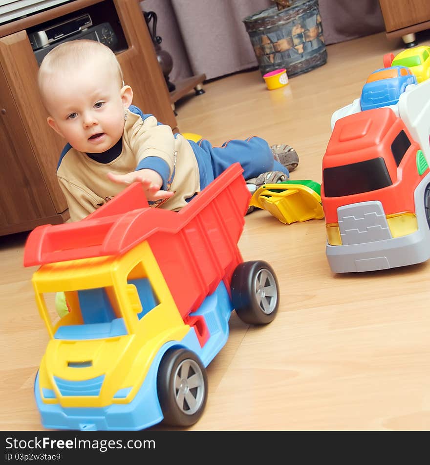 One year boy playing with trucks. One year boy playing with trucks