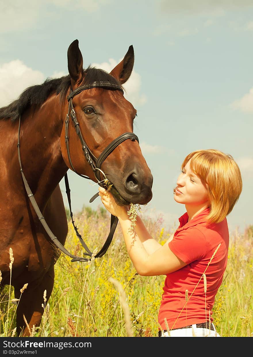 Kissing  of young  girl with your  horse in field