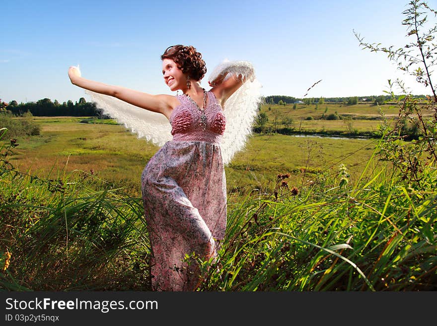 Beautiful girl in dress on field