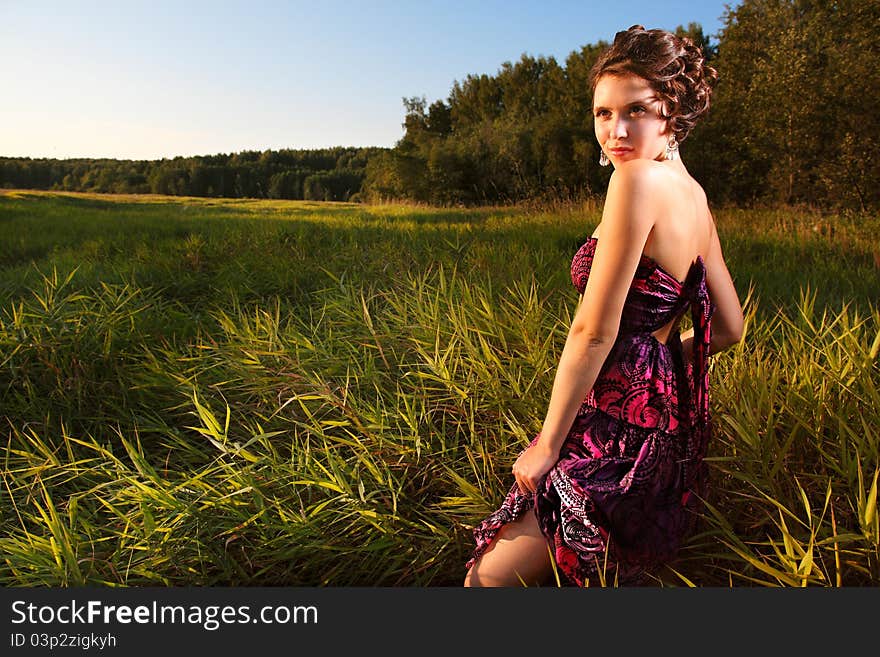 Beautiful girl in dress on field