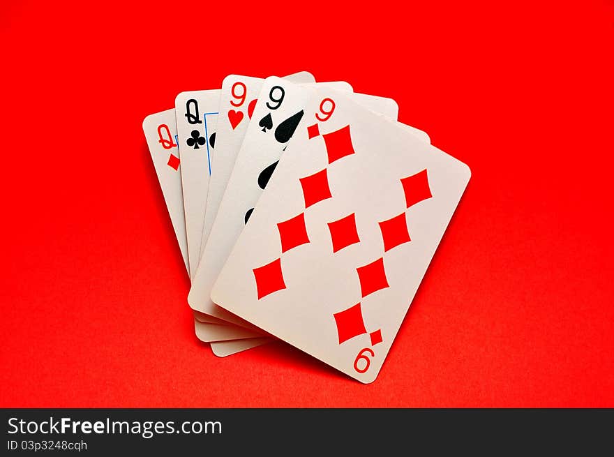 Winning Hand called Full House in Poker on Red Background.