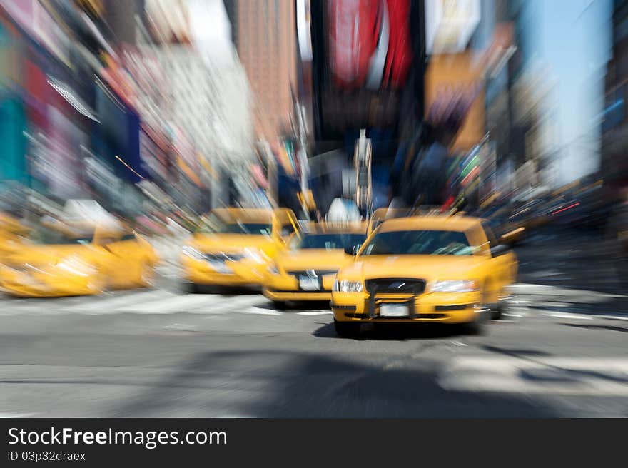 Abstract motion blur of a city street scene with a yellow taxi cabs speeding. Abstract motion blur of a city street scene with a yellow taxi cabs speeding