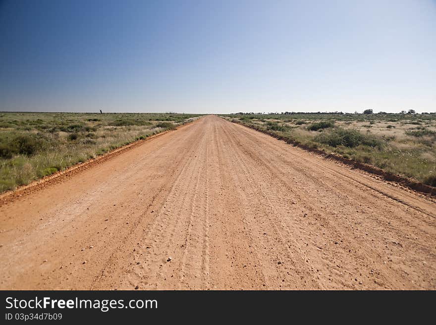 Unsealed country road in Australia stretching off to he horizon. Unsealed country road in Australia stretching off to he horizon