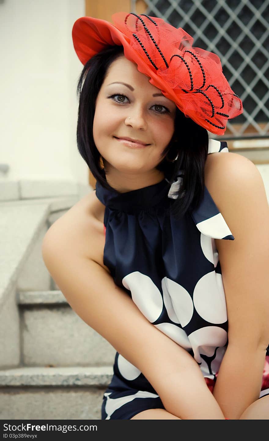 The girl in a hat in an old city in a province