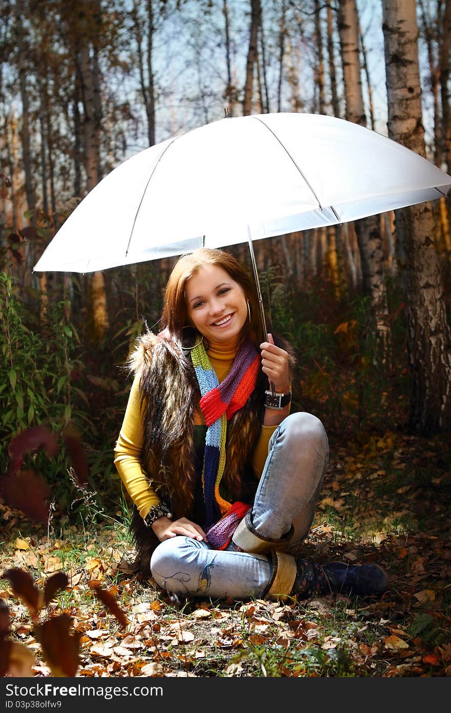 Young attractive smiling girl in autumn forest