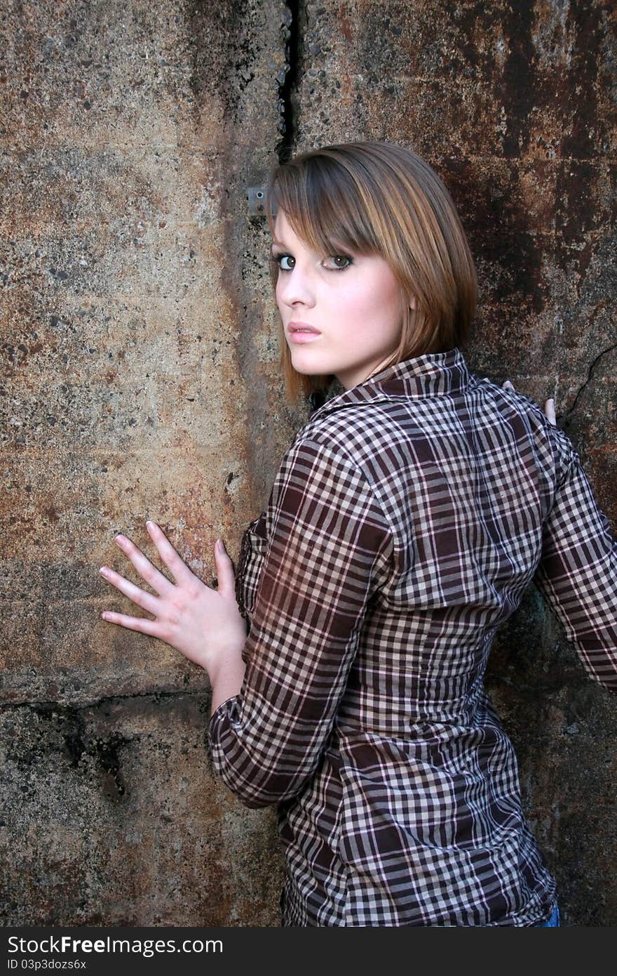 Beautiful woman leaning on wall