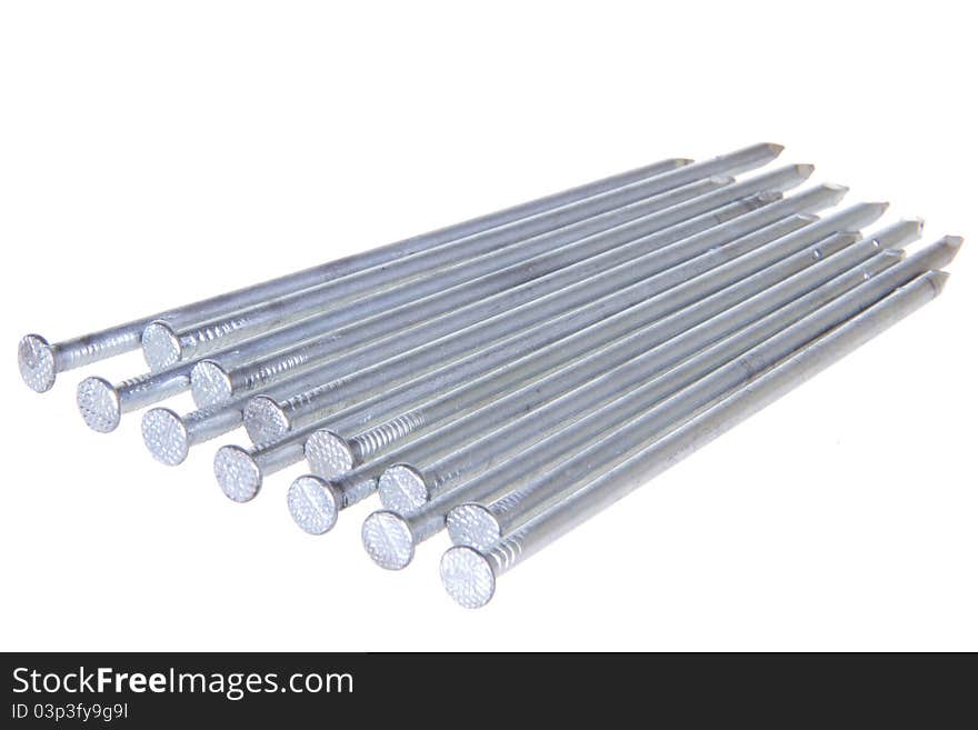 The group of steel nails lying on a white isolated background