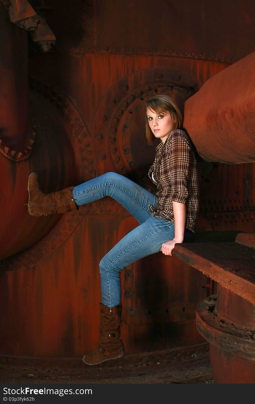 Young woman against old rusty metal