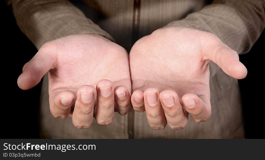 Human hands on a dark background. Human hands on a dark background