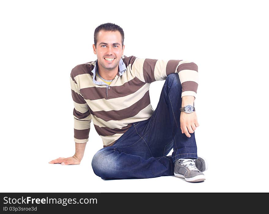 Portrait of a casual young satisfied man sitting relaxed. Isolated on white.