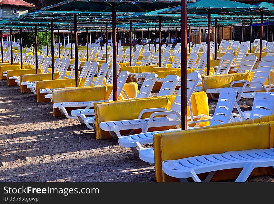 Perfect beach empty sunbeds and umbrellas. Perfect beach empty sunbeds and umbrellas