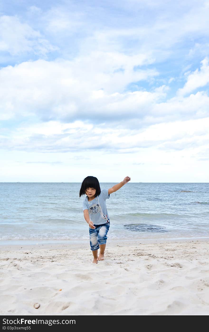 Little Asian Girl Running On The Beach