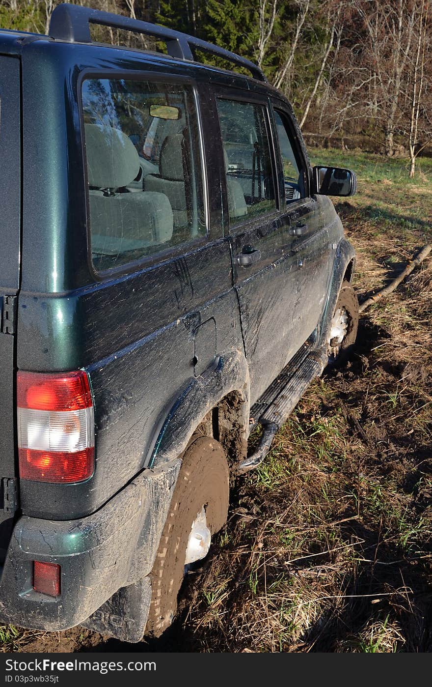 The off-road car in has got stuck in the field