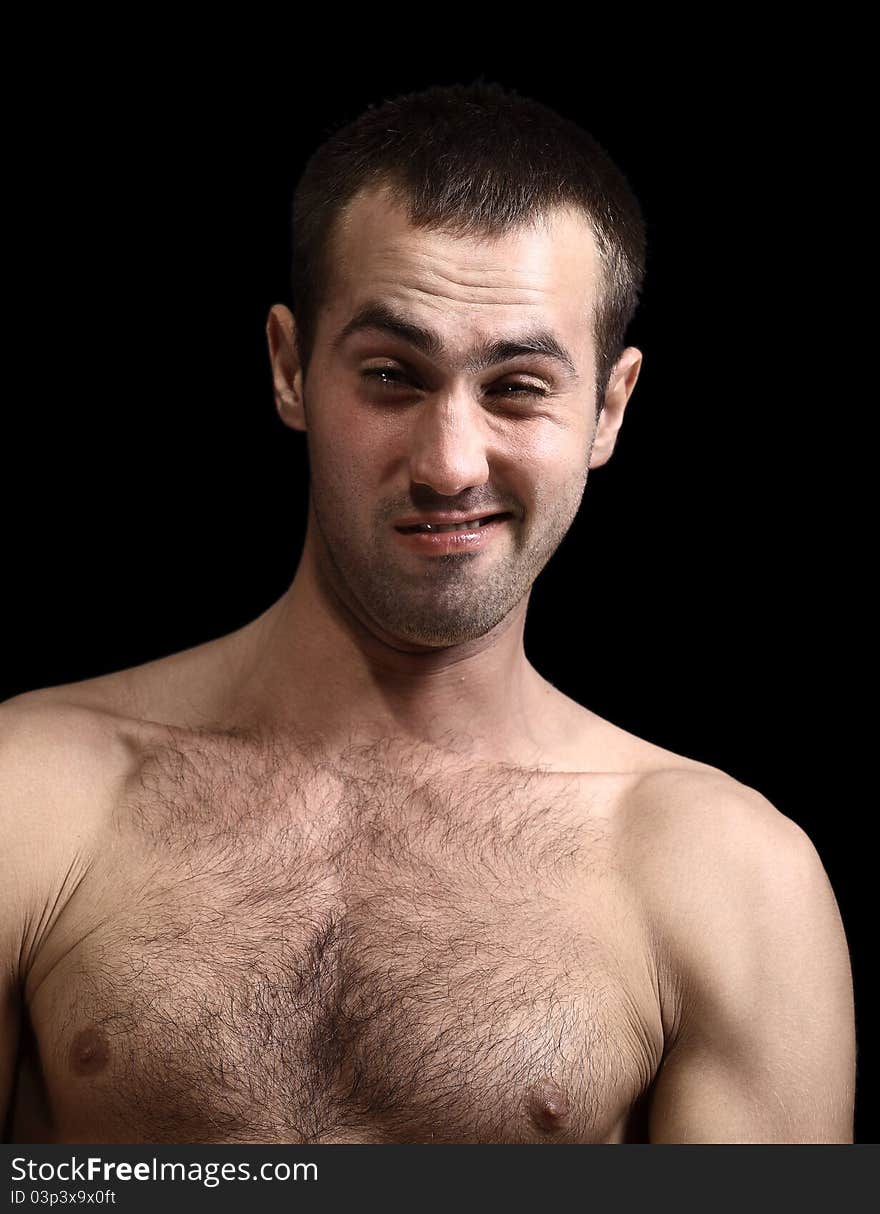 Young man face expressions over black background