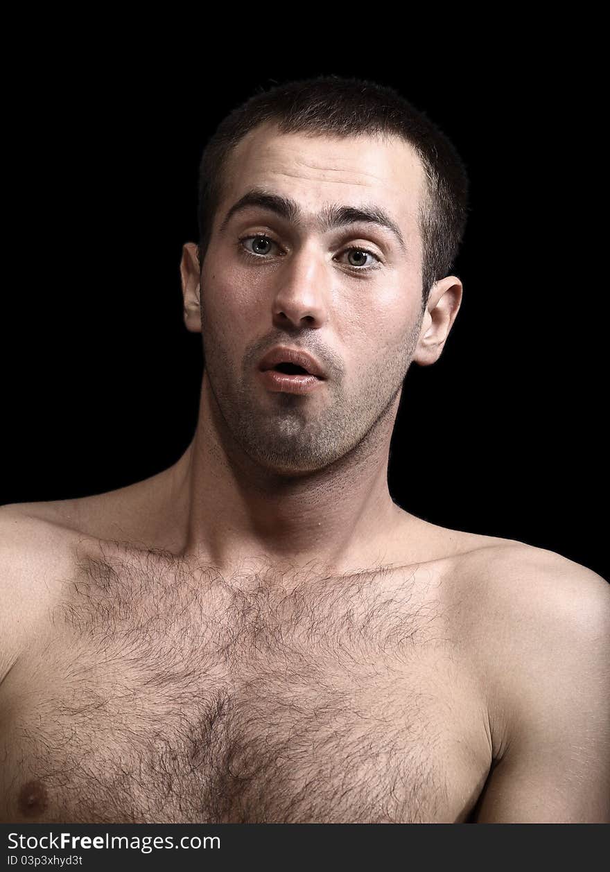 Young man face expressions over black background