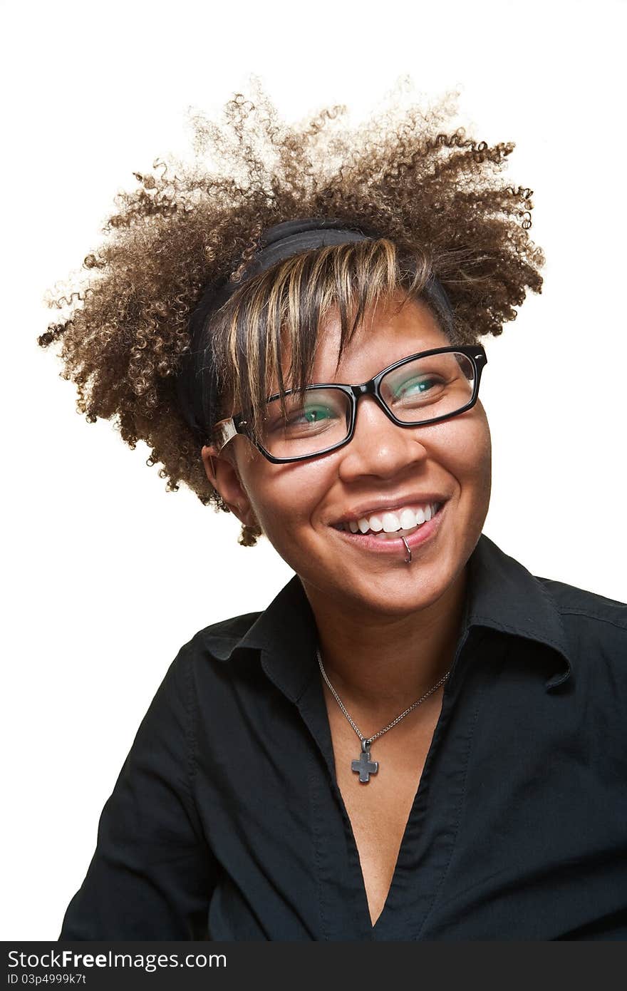 Young African girl smiles towards something off camera in front of a white background. Young African girl smiles towards something off camera in front of a white background.