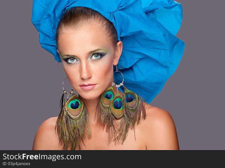 Portrait of a woman in a blue hat with a gray background