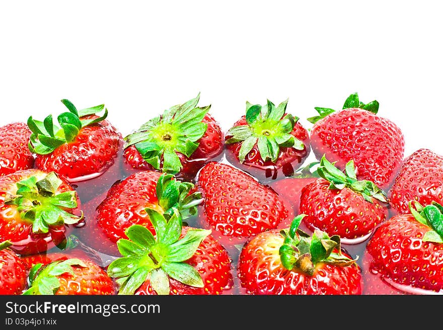 Group of red strawberries in water