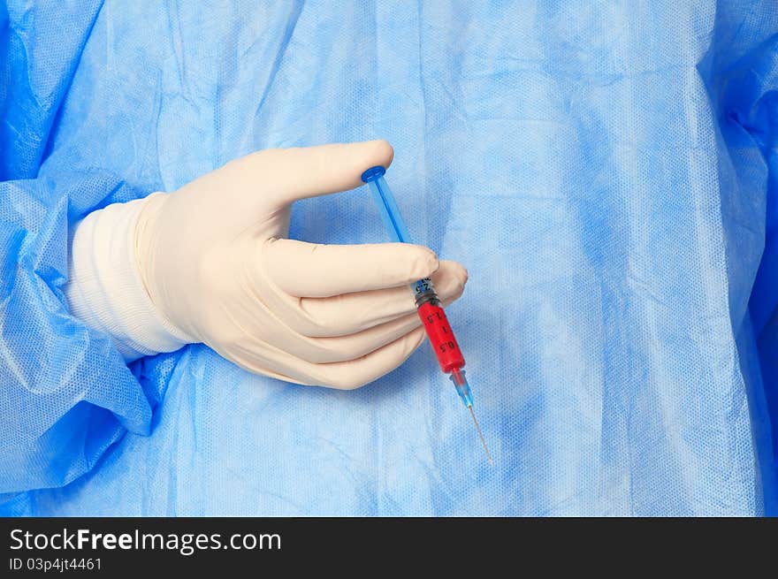 Doctor holding a syringe with new synthetic drug mixed with blood. Doctor holding a syringe with new synthetic drug mixed with blood