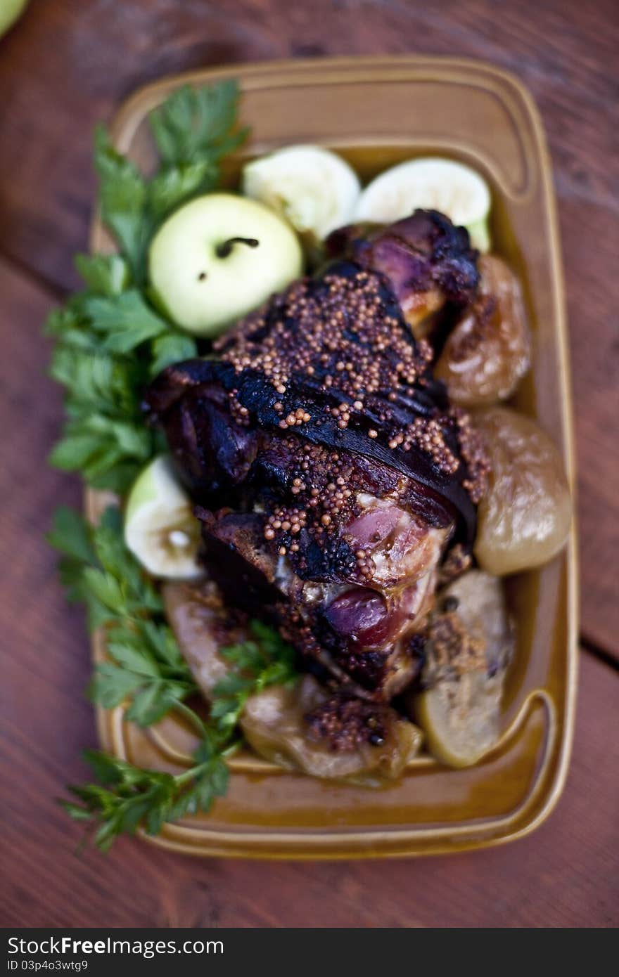 Roasted pork knuckle with beer and mustard on plate