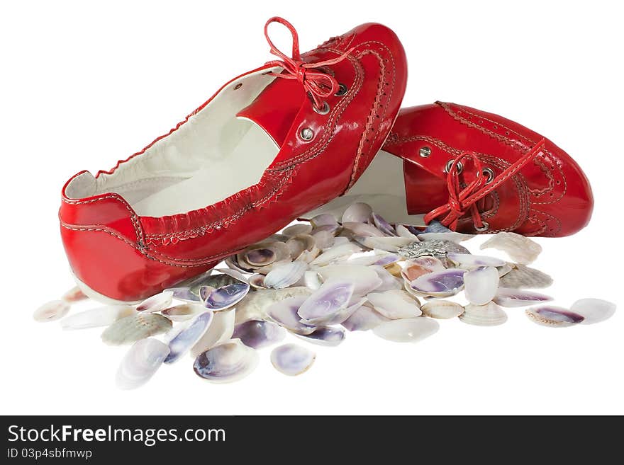 Red lady ballet flat shoes and seashells isolated on white background