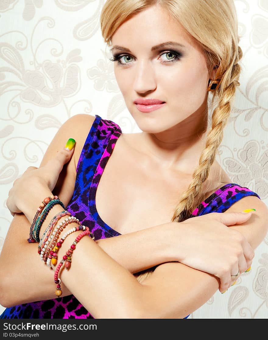 Beautiful blonde girl on a background wall with patterns