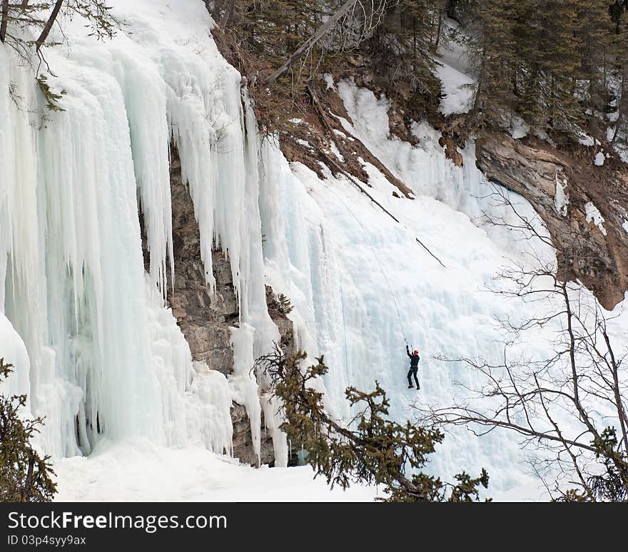 Lonely climber climbing upper fall at Johnston Canyon, Banff National Park, Alberta, Canada. Lonely climber climbing upper fall at Johnston Canyon, Banff National Park, Alberta, Canada