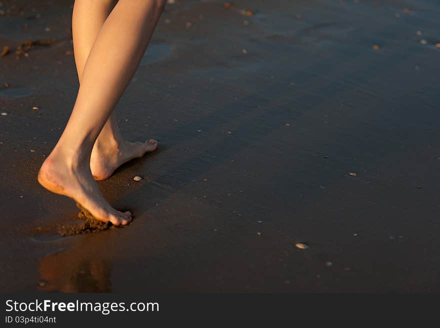 Woman s foot in the water sand