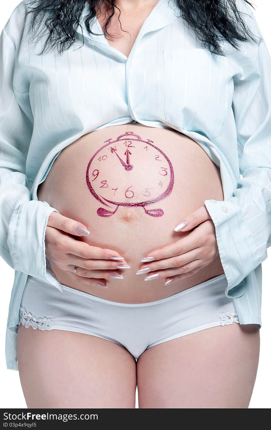 Tummy of pregnant woman with funny drawing over white background. Tummy of pregnant woman with funny drawing over white background