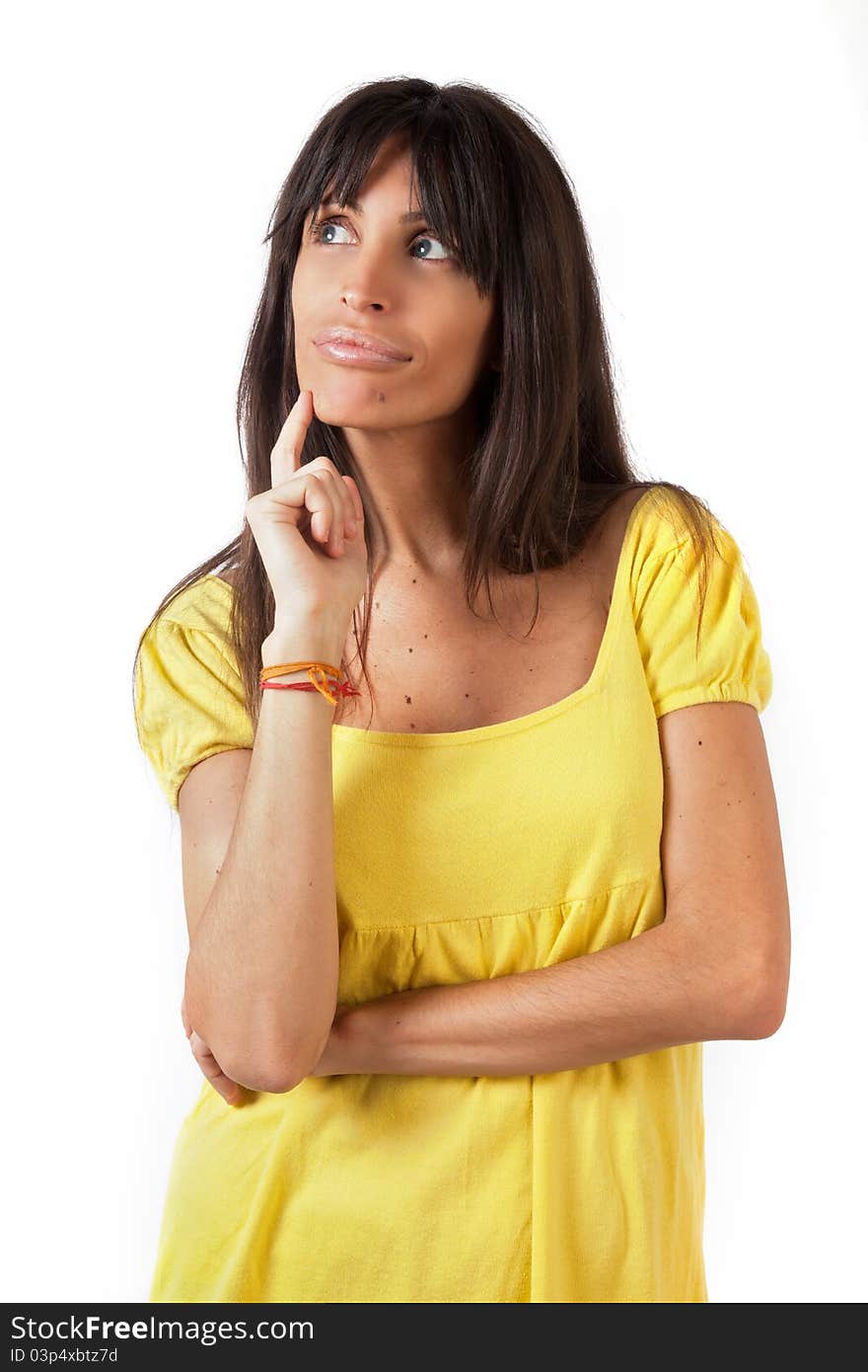 A brunette woman with a yellow top thinking and having a great idea. A brunette woman with a yellow top thinking and having a great idea