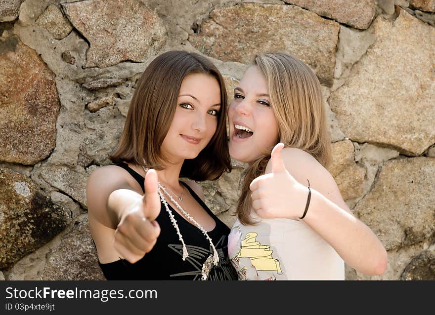 Two happy girls with thumbs up. Two happy girls with thumbs up