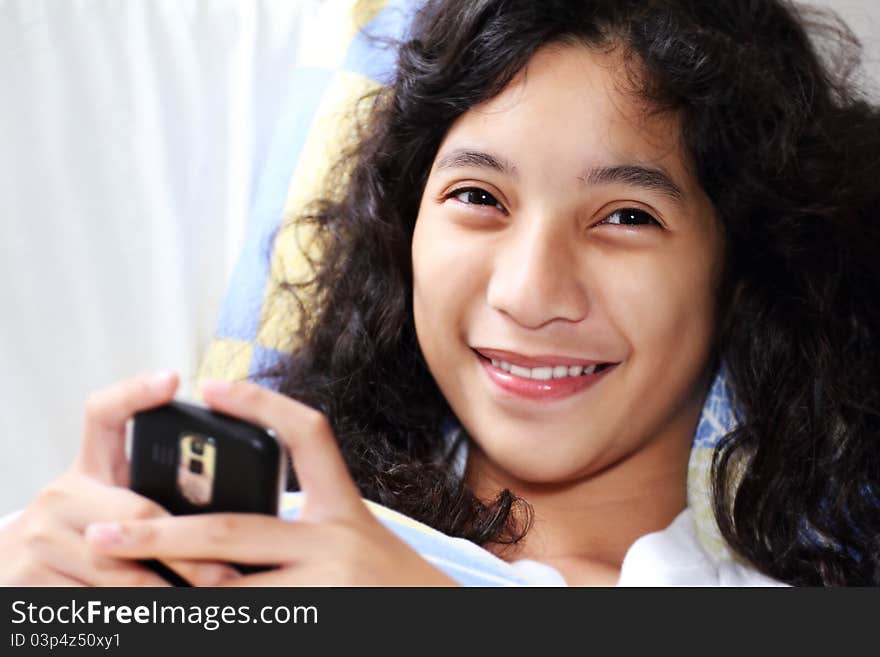 Happy young asian lady holding a cellphone. Happy young asian lady holding a cellphone